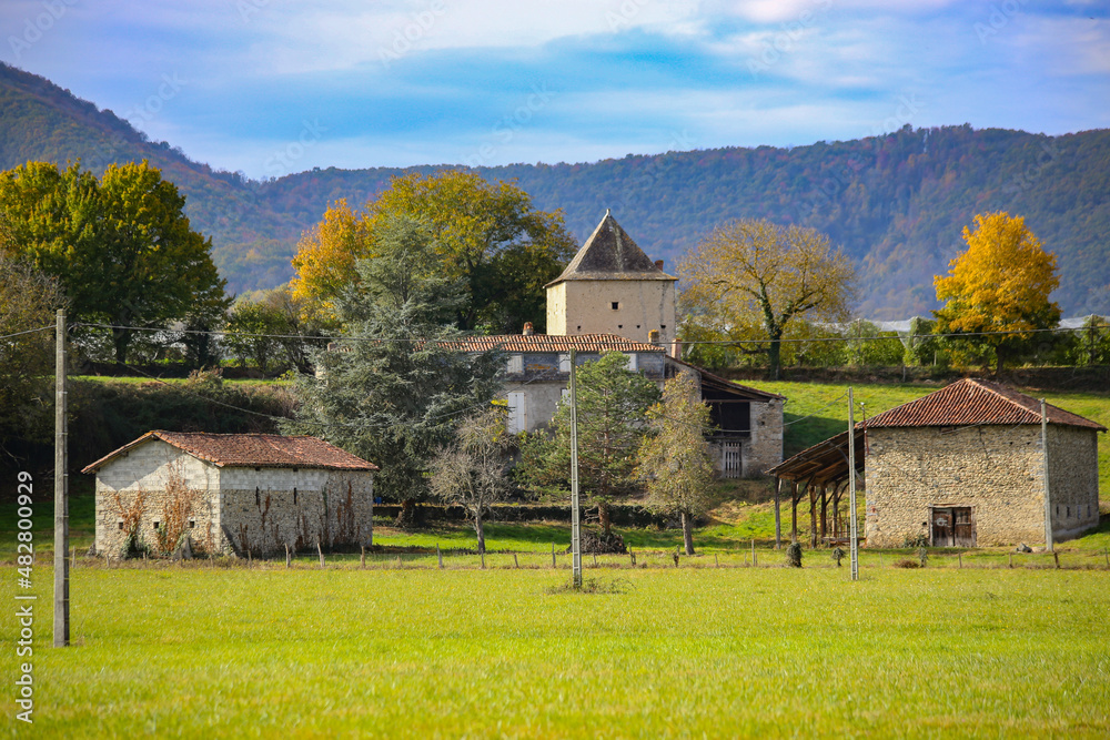 Obraz premium Beautiful autumn landscape at French countryside, farm and houses, Loures-Barousse, Pyrenees, France