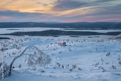Winter time. Cabins in winter. Dubldom on the mountain Volodyanaya Kandalaksha, Murmansk region in Russia. photo