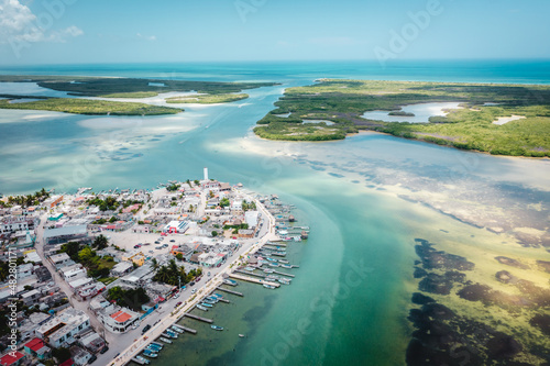 Aerial landscape overlooking the city of Rio Lagartos. The city is surrounded by a beautiful river with azure water. Fishing boats are moored to the shore. Yucatan, Mexico photo