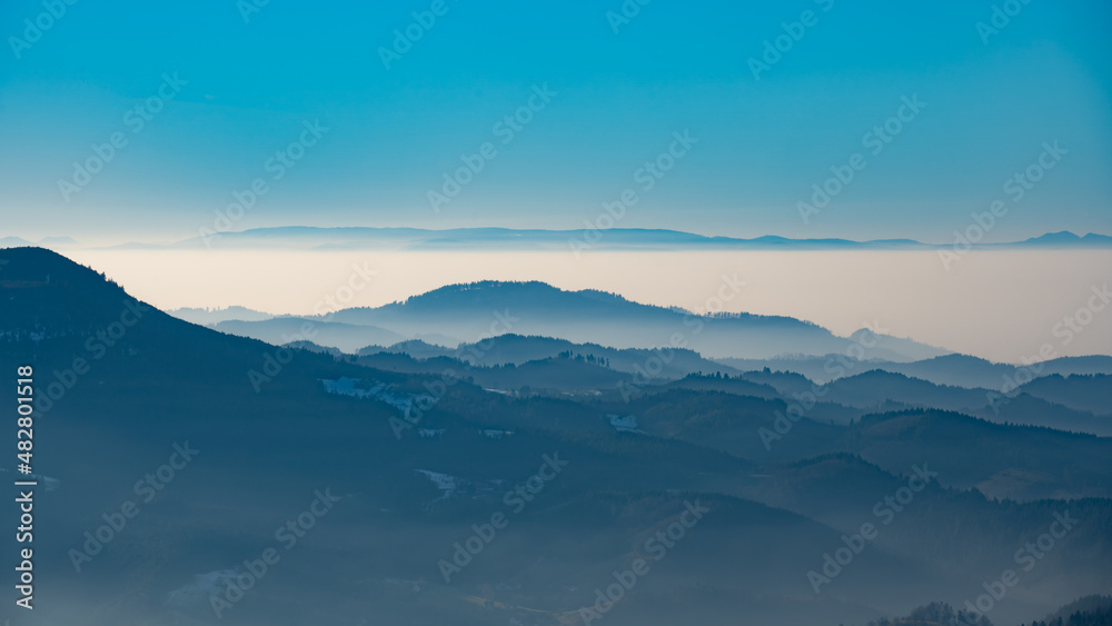 Amazing mystical rising fog forest trees mountains landscape panorama in Black Forest ( Schwarzwald ) Germany with dark silhouette