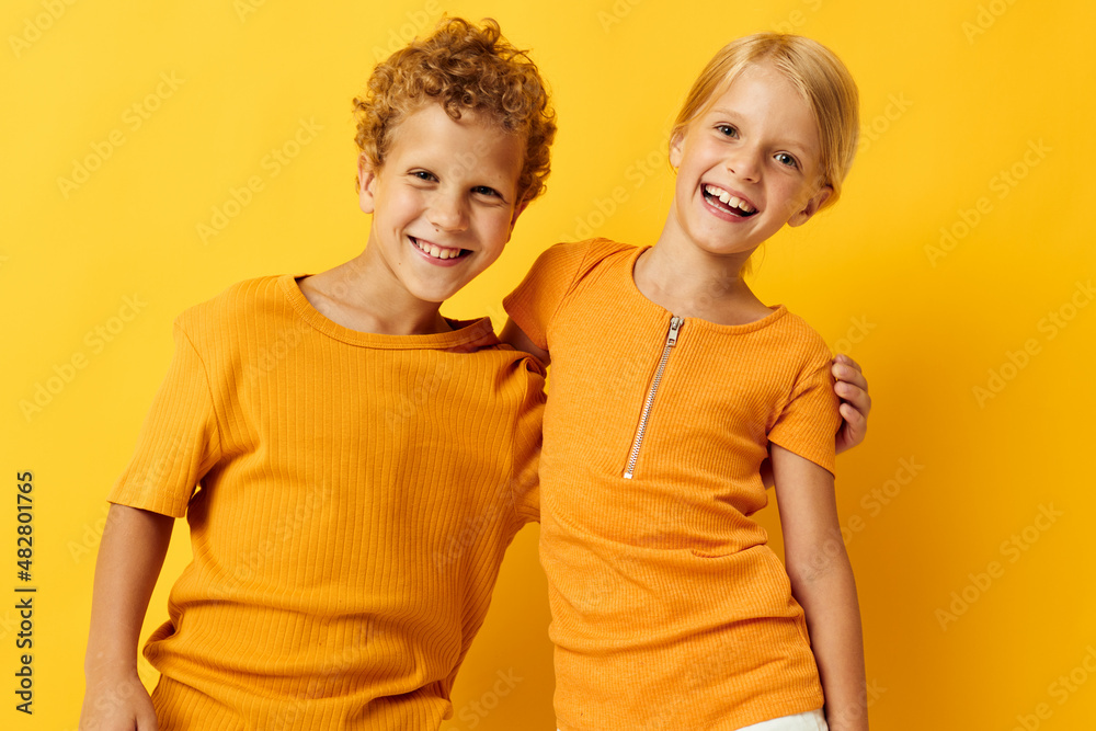 picture of positive boy and girl casual wear games fun together posing isolated background unaltered picture of positive boy and girl casual wear games fun together posing isolated background unaltered