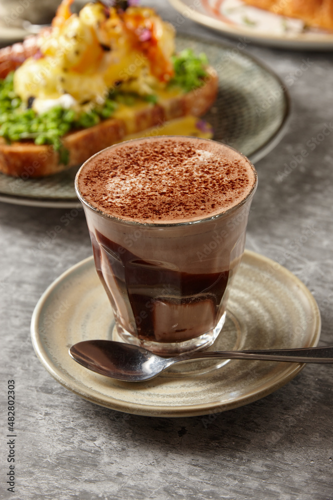 Hot chocolate with healthy meals in background Hot chocolate with healthy meals in background