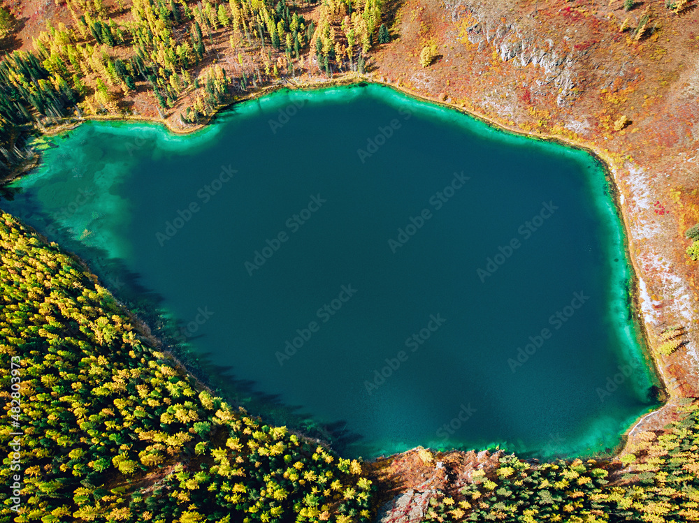 Top view of a huge lake with brilliant turquoise water which is located ...