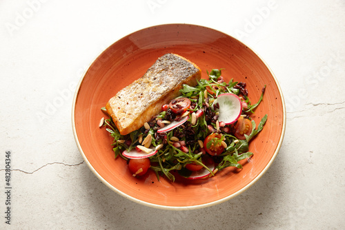 Roast salmon fillet and salad in bowl photo