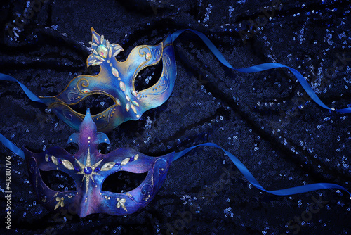 Photo of elegant and delicate Venetian mask over blue dark background
