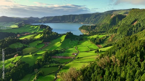 Azores nature on sunny day. Aerial shot of green meadows, mountains and Furnas lake on Sao Miguel Island, Azores, Portugal photo