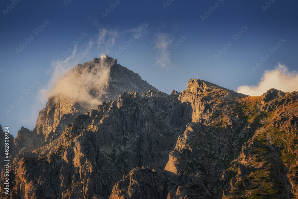 Lomnicky stit peak with observatory at sunset with clouds