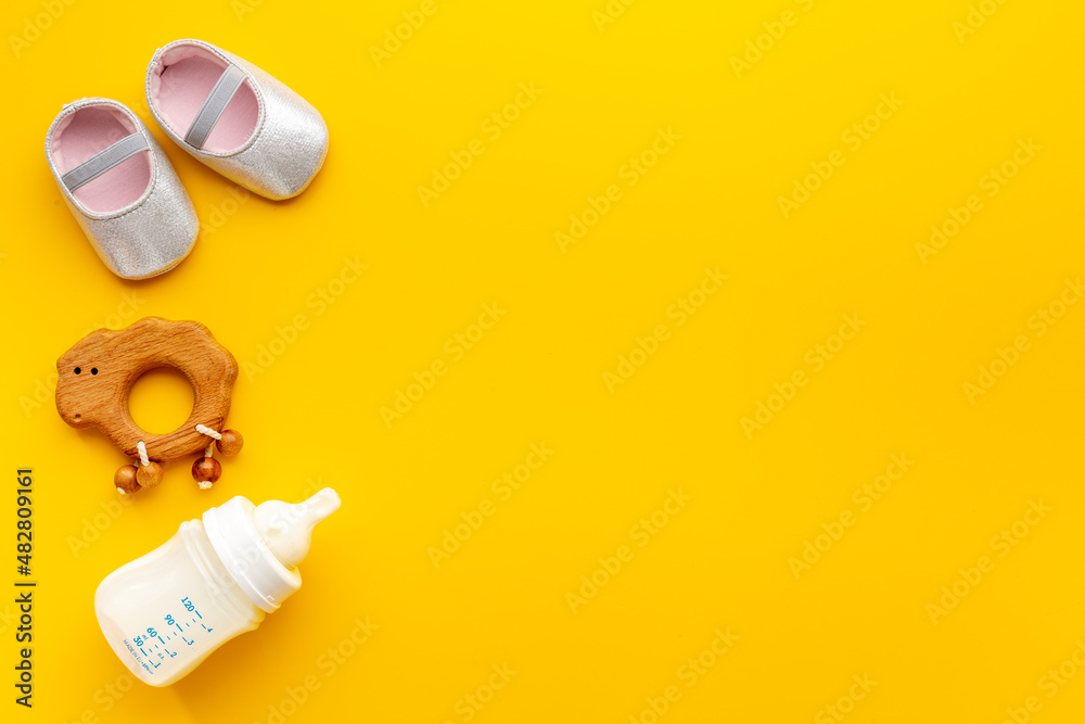 Baby girl pink shoes with milk and toy. Newborn set background Baby girl pink shoes with milk and toy. Newborn set background