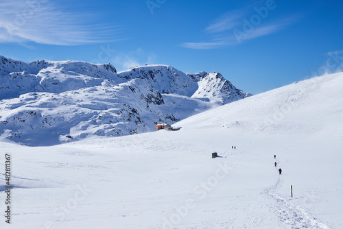 Rila Mountain in the winter with people trekking to Ivan Vazov refuge, Bulgaria