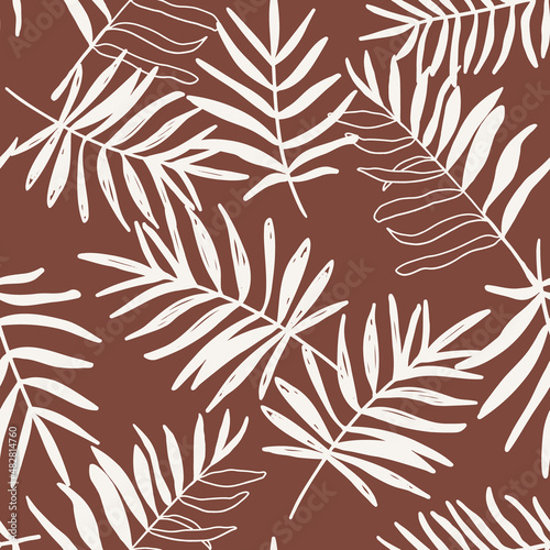 Palm tree leaves seamless repeat pattern. Random placed, hand drawn plant elements all over surface print on brown background.
