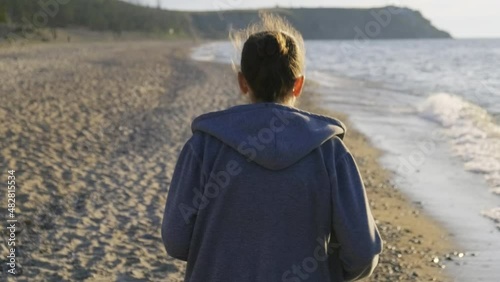 A woman runs along the seashore
