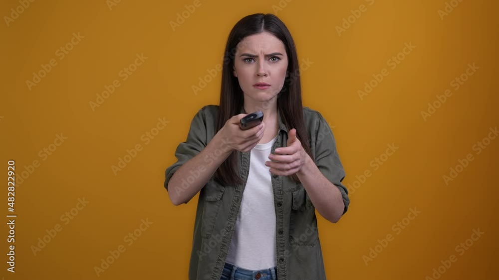 Annoyed lady remote control low energy battery isolated shine color background Annoyed lady remote control low energy battery isolated shine color background