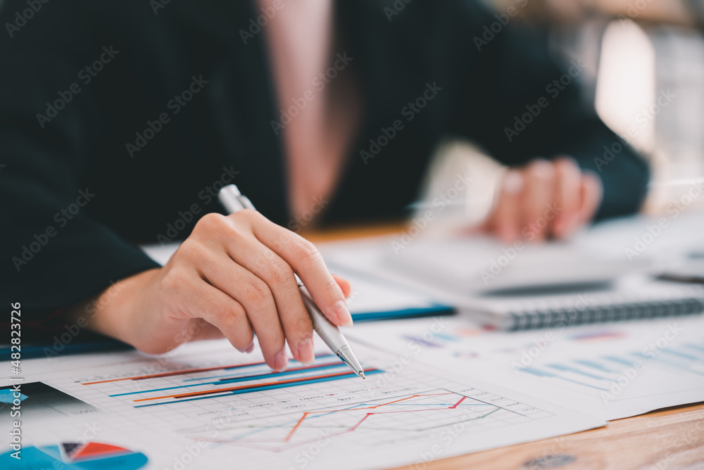 business woman or accountant who are using a calculator to calculate business data Accounting documents and laptop computer at the office business idea business woman or accountant who are using a calculator to calculate business data Accounting documents and laptop computer at the office business idea