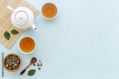 Tea ceremony with with white teapot and two cups, top view