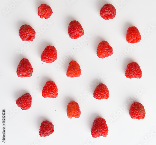 Raspberry fresh fruits photographed on a white background create great texture. Raspberries food photography. Details of this tasty forest fruits.