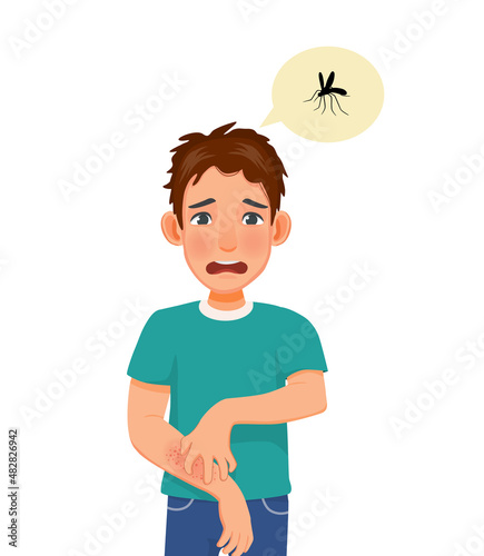 Young man scratching his itchy arm having skin dry skin problems, animals or food allergy, dermatitis, insect mosquito bites and irritation
