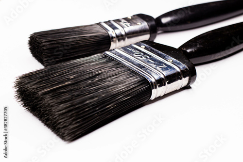 Paint brushes 50mm in the foreground and 25mm in the second on a white background photo