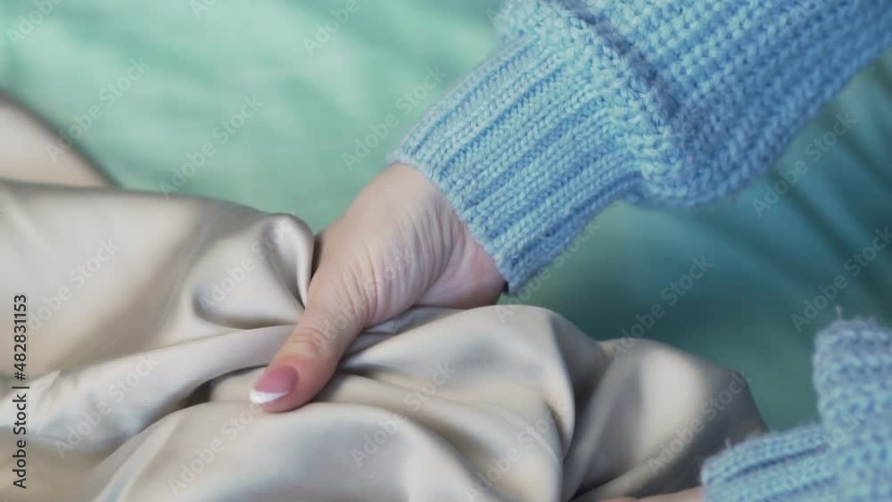 Female Hands Stroking Touching Silky Shiny Smooth Texture Natural Light Fabric Satin, Tencel, Lyocell, Eucalyptus Fiber, Silk, Luxury Satin, Textile, Material, Closeup. Female Hands Stroking Touching Silky Shiny Smooth Texture Natural Light Fabric Satin, Tencel, Lyocell, Eucalyptus Fiber, Silk, Luxury Satin, Textile, Material, Closeup.