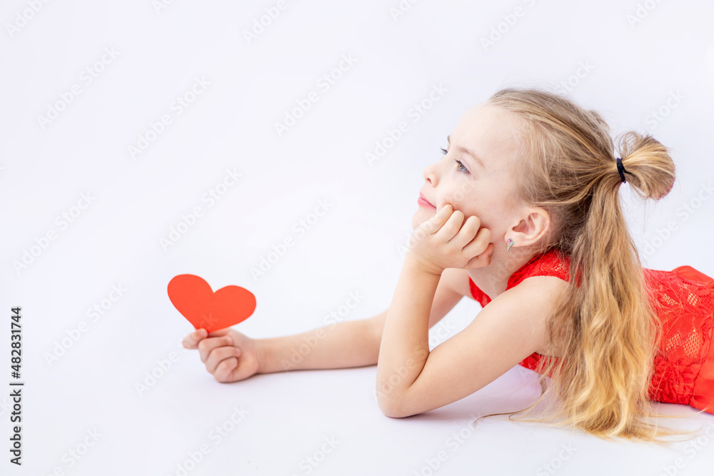 a cute little girl child in a red dress holds hearts on a white isolated background, the concept of Valentine's day, a place for text a cute little girl child in a red dress holds hearts on a white isolated background, the concept of Valentine's day, a place for text