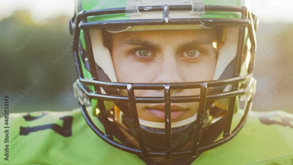 Im ready. Professional hero player looking at the camera while being ready to win the championship. Determination, american football, skill, power concept. Dramatic portrait Im ready. Professional hero player looking at the camera while being ready to win the championship. Determination, american football, skill, power concept. Dramatic portrait