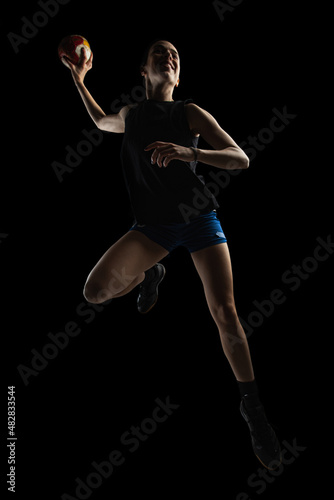 Fotografi Handball player posing on dark background
