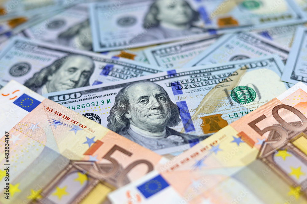 US dollars and euro banknotes. Concept of exchange rate, investment and trade between the United States and European Union US dollars and euro banknotes. Concept of exchange rate, investment and trade between the United States and European Union