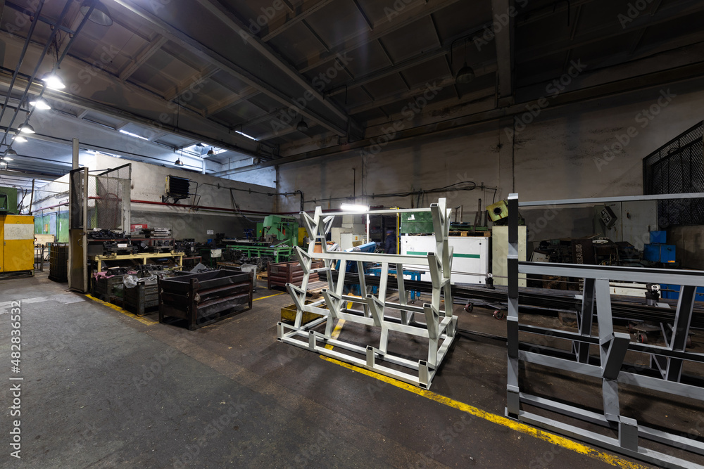 Photo of modern automatic automobile manufacturing workshop. The interior of a big industrial building of factory with steel constructions. Plant of car production. Industrial concept Photo of modern automatic automobile manufacturing workshop. The interior of a big industrial building of factory with steel constructions. Plant of car production. Industrial concept