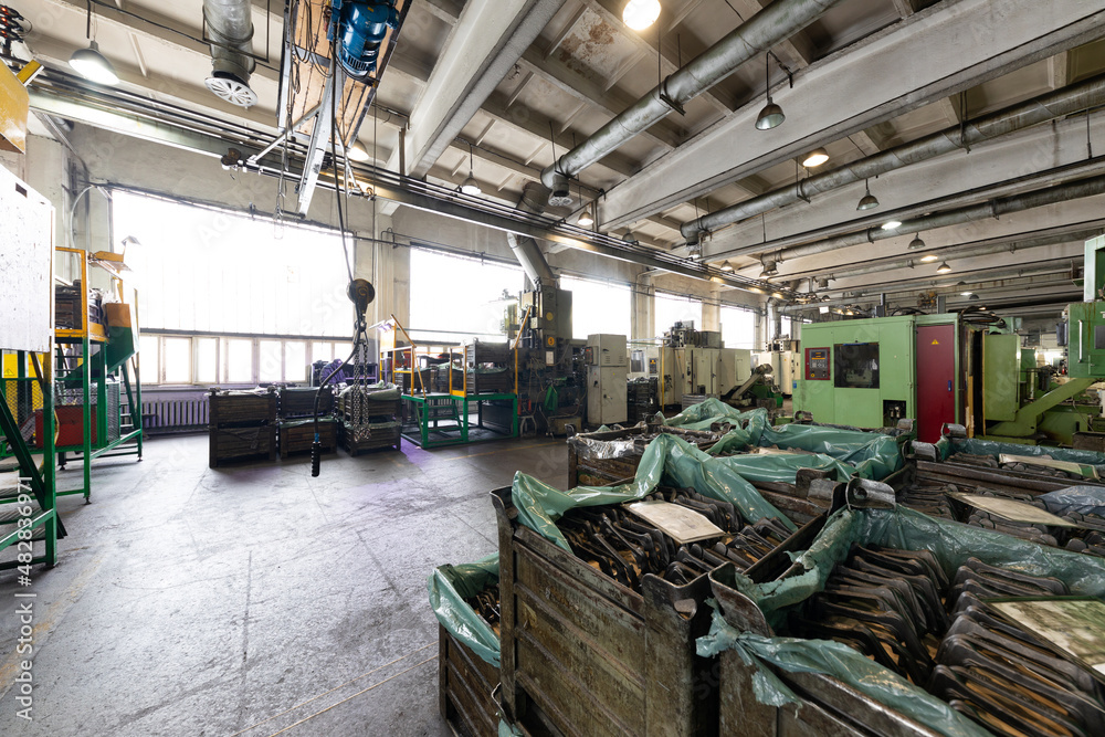 Photo of modern automatic automobile manufacturing workshop. Factory with steel constructions. Plant of car production. Industrial scenery background Photo of modern automatic automobile manufacturing workshop. Factory with steel constructions. Plant of car production. Industrial scenery background
