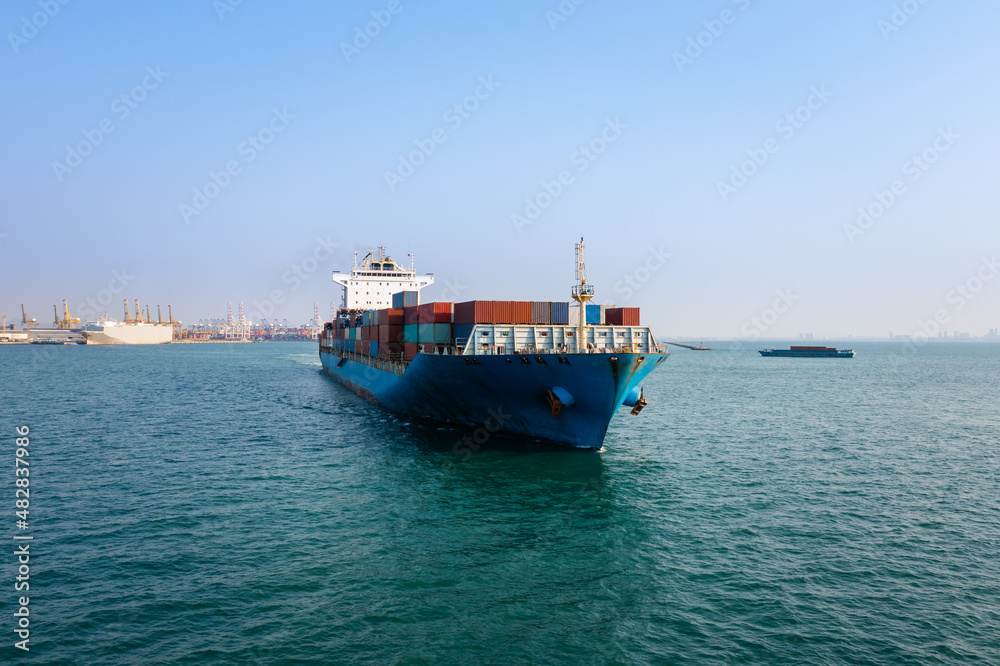 Container ship carrying for import and export, business cargo logistic and transportation by container ship in open sea, Aerial view
