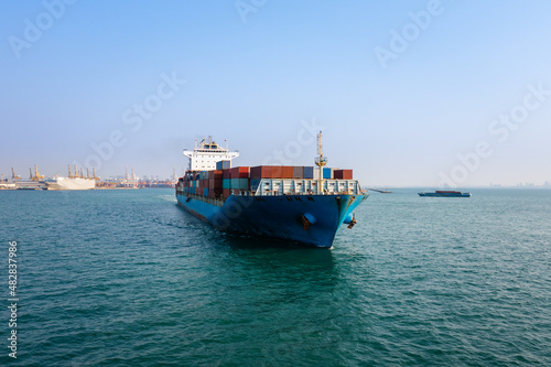 Container ship carrying for import and export, business cargo logistic and transportation by container ship in open sea, Aerial view