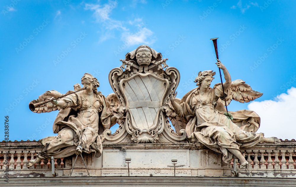 Two trumpeting angels representing Fame, the Corsini family Coat of Arms on Palazzo della Consulta on Quirinale Hill, Rome. Built in 1735, it houses the Constitutional Court of the Italian Republic.