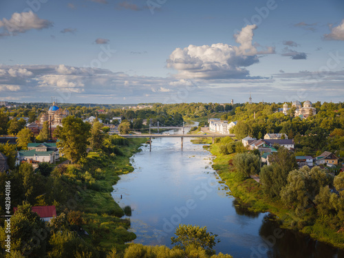 summer travel to Russia  Torzhok city  Tver region. View on old buildings at the embankment from the bridge across the Tvertsa river. Rural landscape