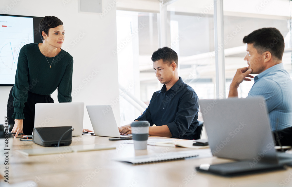 Keeping their company right on track. Shot of a group of businesspeople having a meeting in a modern office. Keeping their company right on track. Shot of a group of businesspeople having a meeting in a modern office.