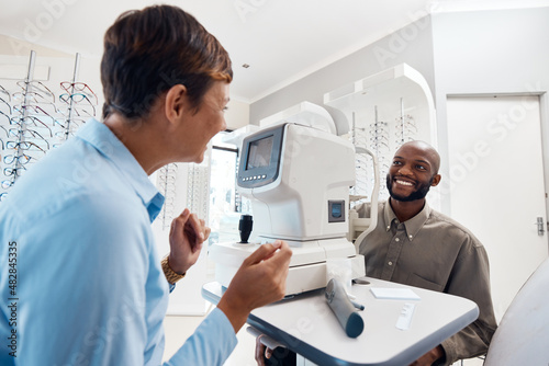 Your vision is better than ever. Shot of an optometrist examining her patients eyes with an autorefractor.
