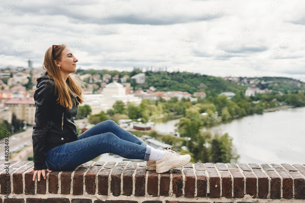 Woman on view point with amazing view. Cute female tourist in Prague, Czech republic.