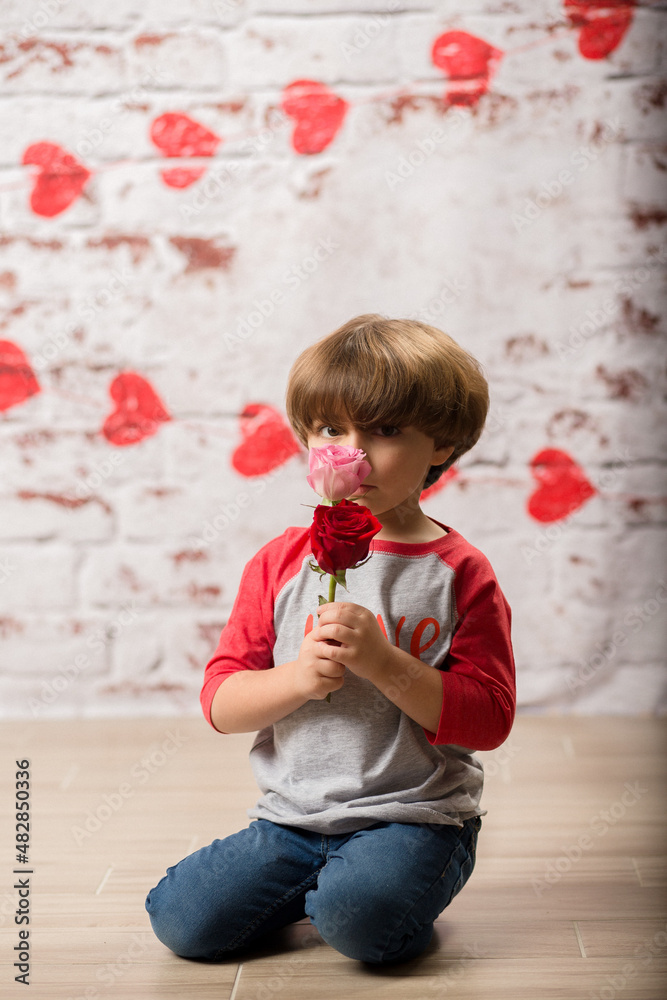 Fototapeta premium Boy small child posing for kisses for valentines day charging cute kid making faces being sweet. 