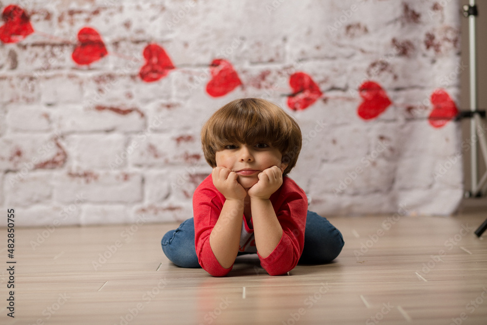 Fototapeta premium Boy small child posing for kisses for valentines day charging cute kid making faces being sweet. 