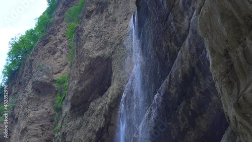 Stunning view of the beautiful Seven Sisters waterfall in the Geiranger fjord, Norway. Powerful streams of raging water fall from the 250m high jagged cliffs joining with the calm waters of the sea. photo