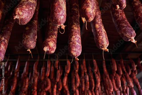 Homemade sausages hanging to dry photo