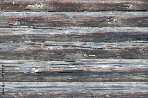 Wooden background made of gray old worn logs