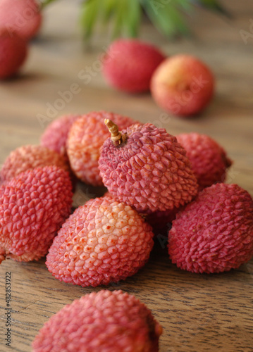 Pink lychees on a wooden background