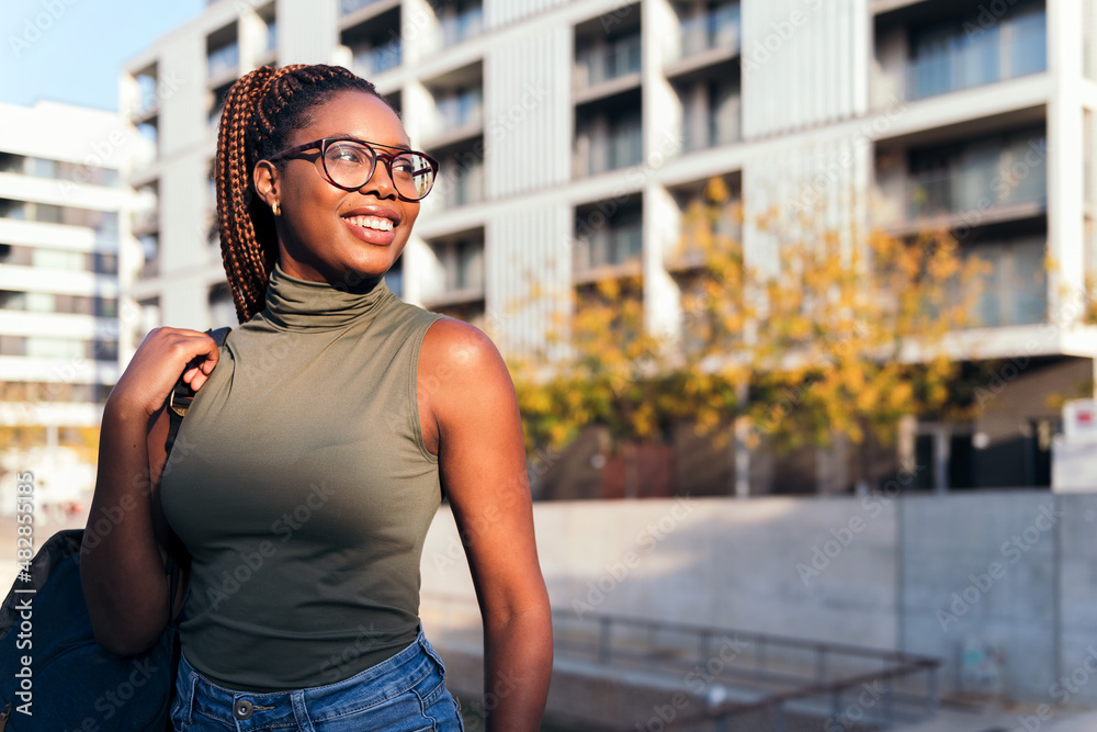 smiling young african student with glasses