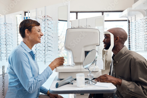 Eye care that's clearly the best. Shot of an optometrist examining her patients eyes with an autorefractor.