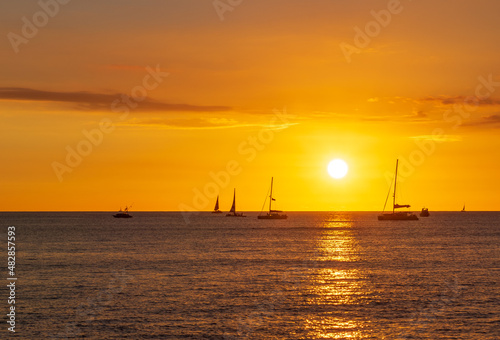 waikiki hawaii sunset over the sea © Ali