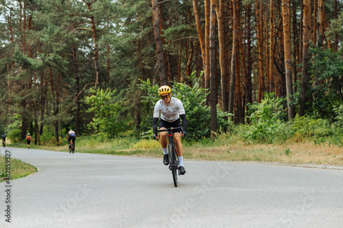 Male cyclist spends time actively cycling in the woods outdoors. Active recreation on a bicycle.