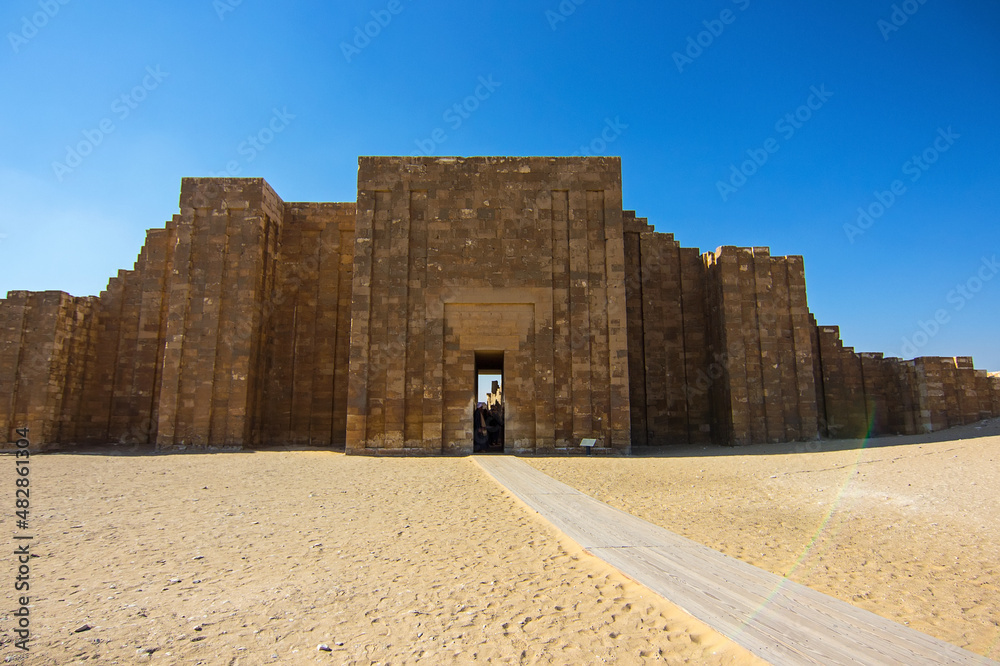 Entrance gate to the Saqqara necropolis with ancient Step pyramid of Djoser, the oldest pyramid of Egypt, archaeological and historical site on the south of Cairo, North Africa Entrance gate to the Saqqara necropolis with ancient Step pyramid of Djoser, the oldest pyramid of Egypt, archaeological and historical site on the south of Cairo, North Africa