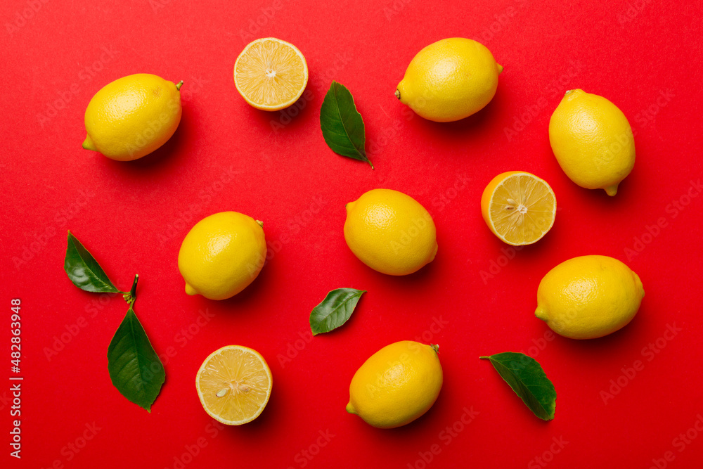 Many fresh ripe lemons as colored background, top view. Elegant background of lemon and lemon slices Top view flat lay