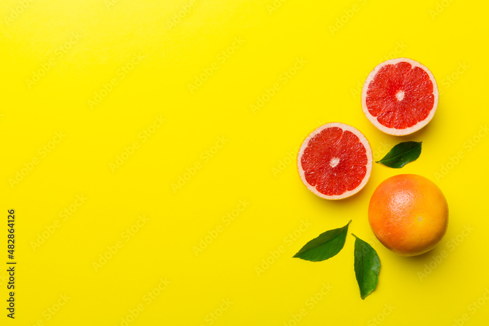 fresh Fruit grapefruit with Juicy grapefruit slices on colored background. Top view. Copy Space. creative summer concept. Half of citrus in minimal flat lay with copy space fresh Fruit grapefruit with Juicy grapefruit slices on colored background. Top view. Copy Space. creative summer concept. Half of citrus in minimal flat lay with copy space