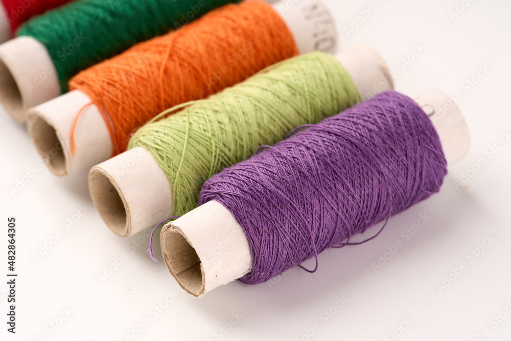 Sewing threads. Spool of thread with on white isolated background. Multicolor sewing threads background. Sewing threads. Spool of thread with on white isolated background. Multicolor sewing threads background.