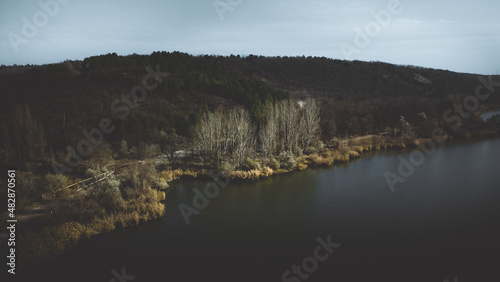 Aerial view of the forest, mountains and the Yagorlyk river. Dark and gloomy landscape, artistic photo processing.